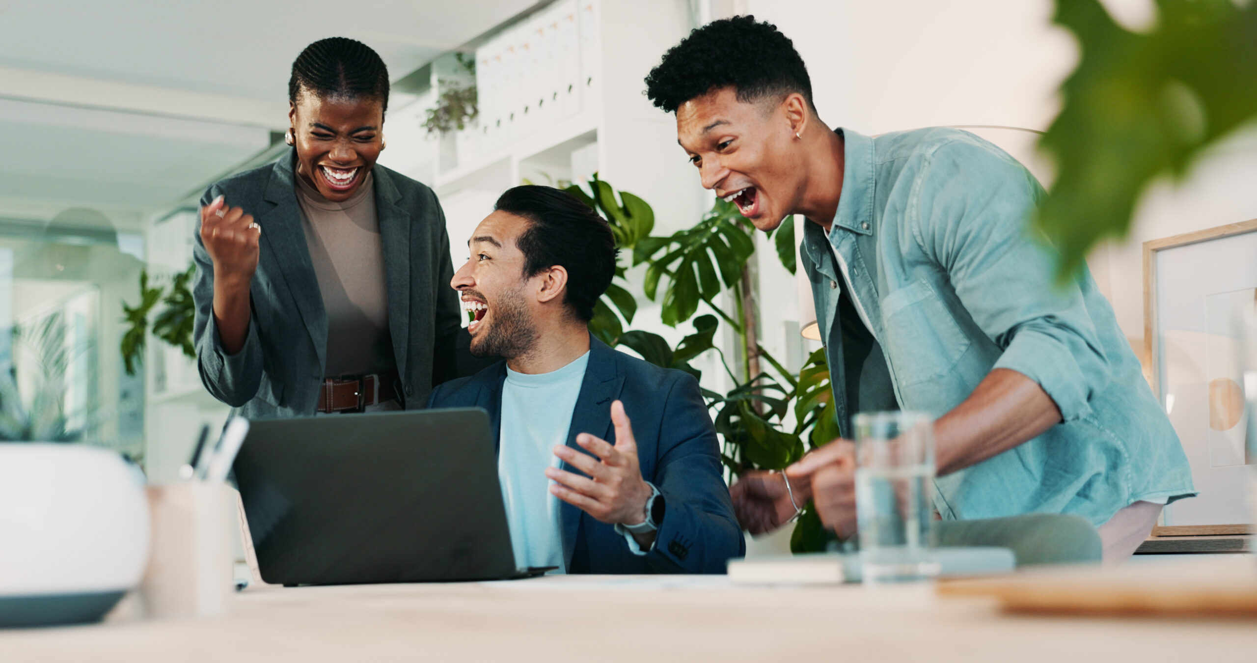 Office, meeting and celebration for laptop, proposal and research with approval for report. Man, woman and excited for small business, teamwork and collaboration for partnership or b2b project