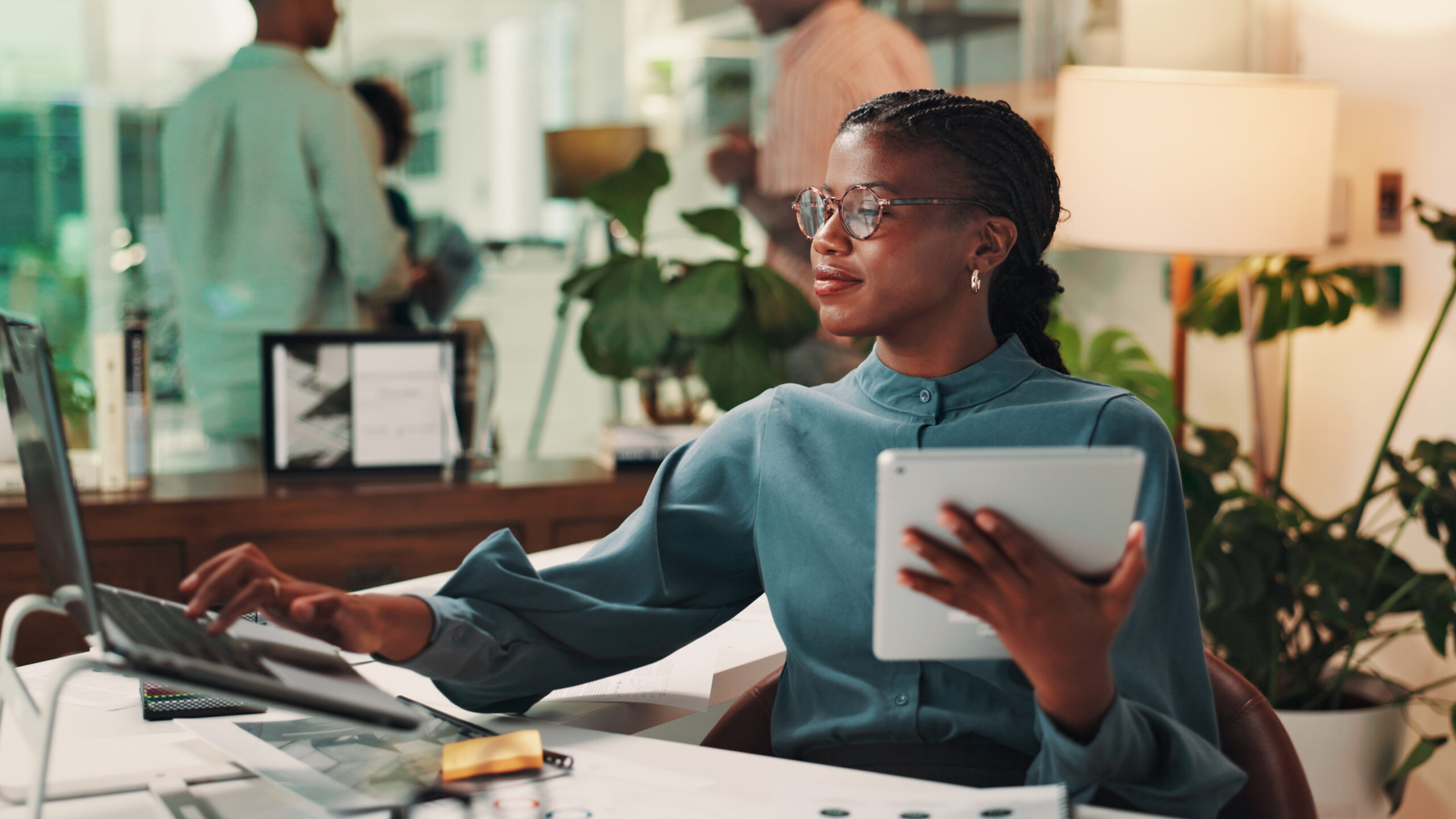 Happy, tablet and woman with laptop, office and media strategist with info, typing and digital marketing. Online, smile and research for target audience, planning and person with tech in business