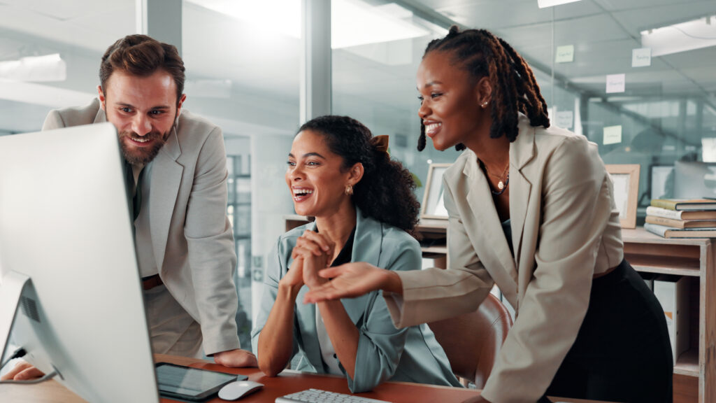 Computer, group and business people with discussion for project, insurance sales or risk management. Happy team, meeting or planning on desktop for financial policy, brainstorming or laugh in office